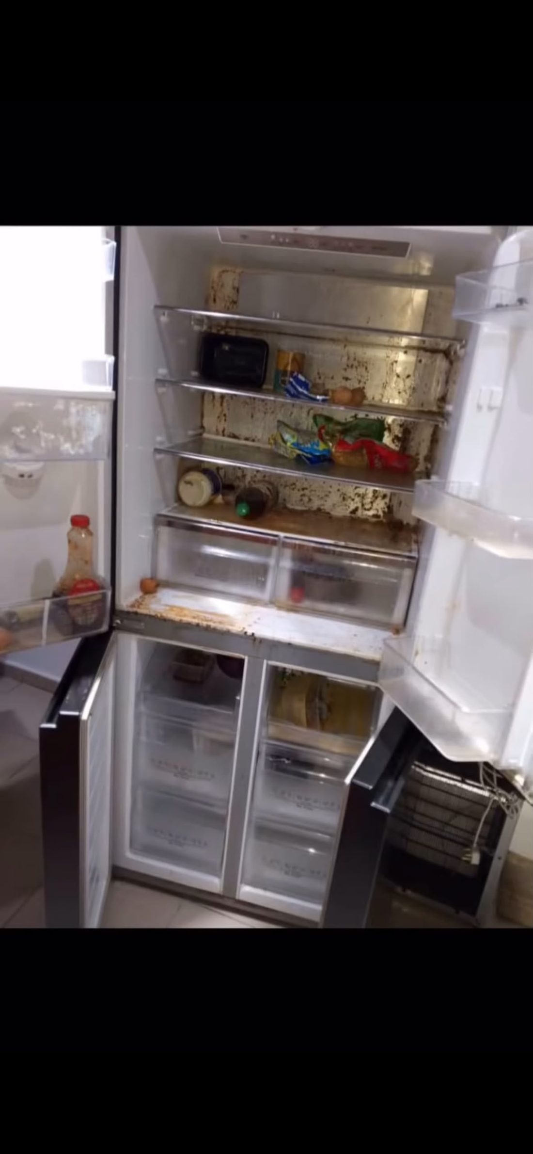 Refrigerator interior with heavy grime and rust stains