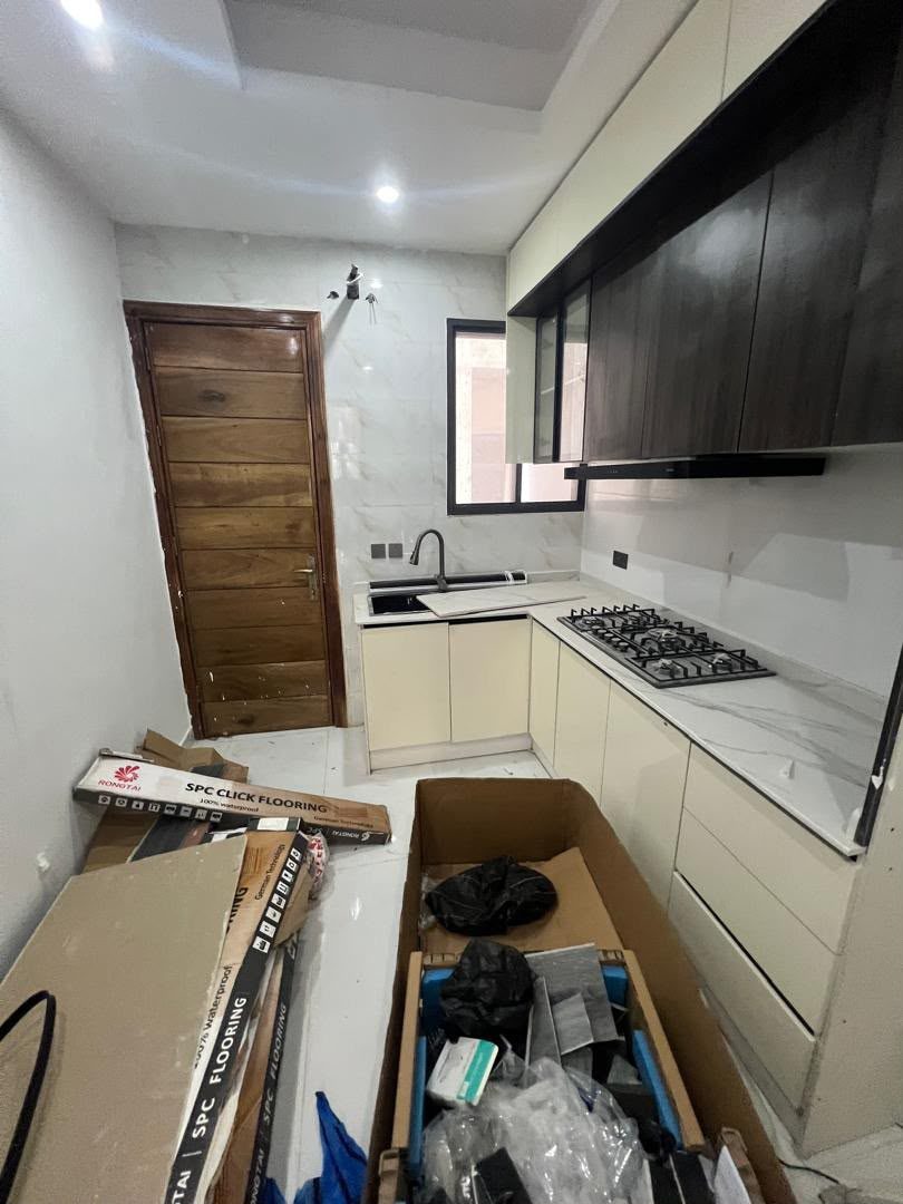 Kitchen before deep clean, construction debris on counters